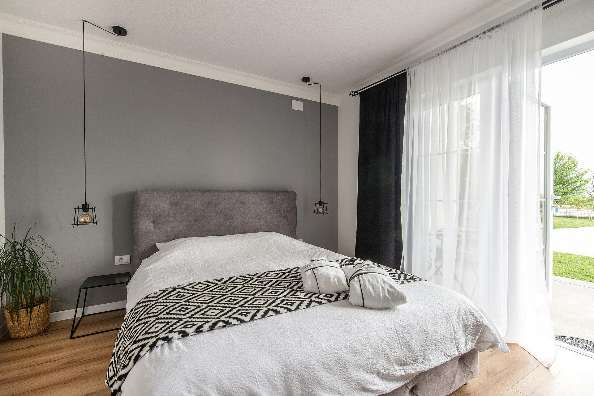 Bright accommodation bedroom with an open window